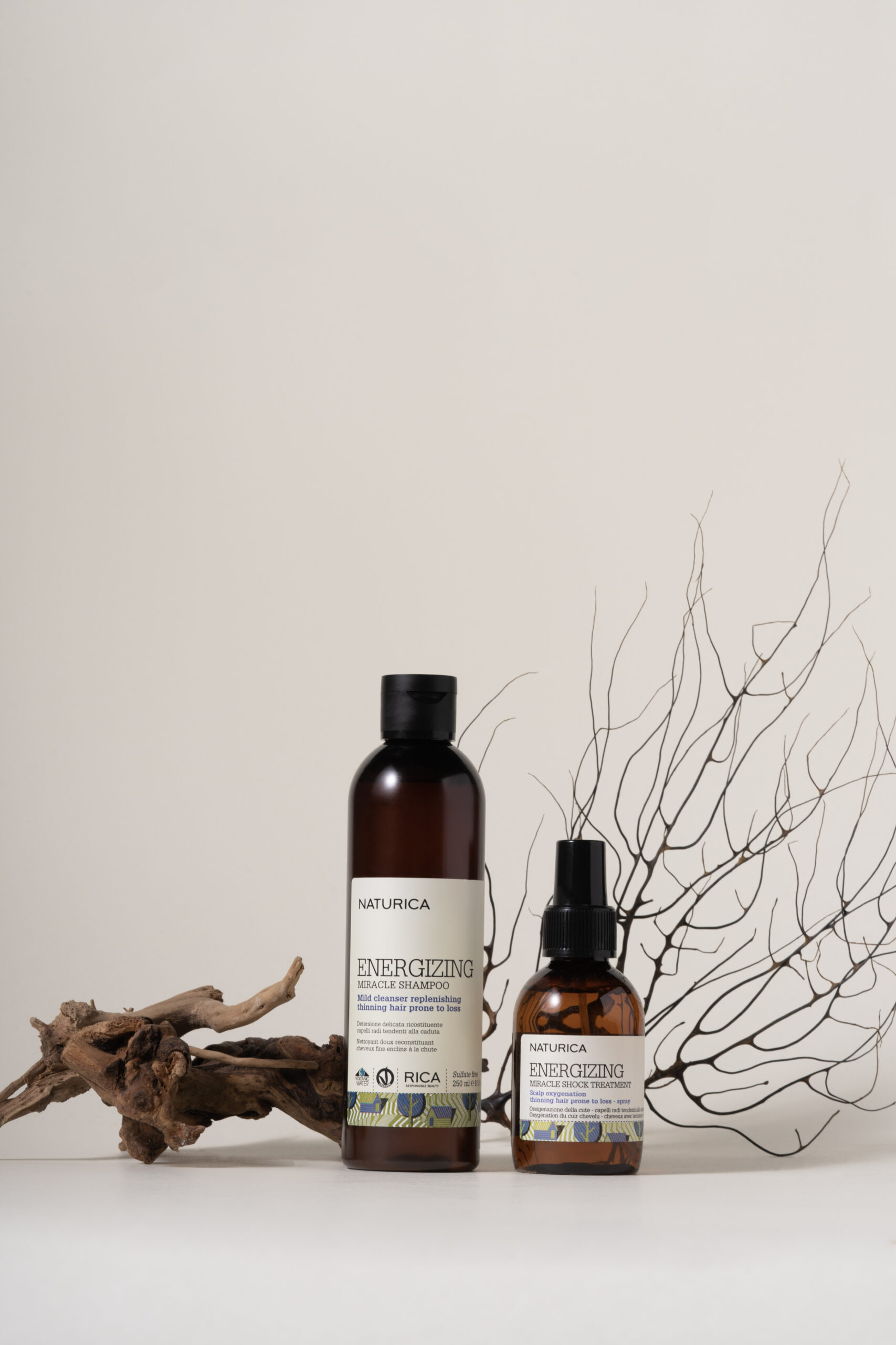 RICA Naturica Energizing Miracle Shampoo and Miracle Shock Treatment – revitalizing hair care duo for thinning hair, enriched with botanical ingredients, styled with natural elements for an organic aesthetic.